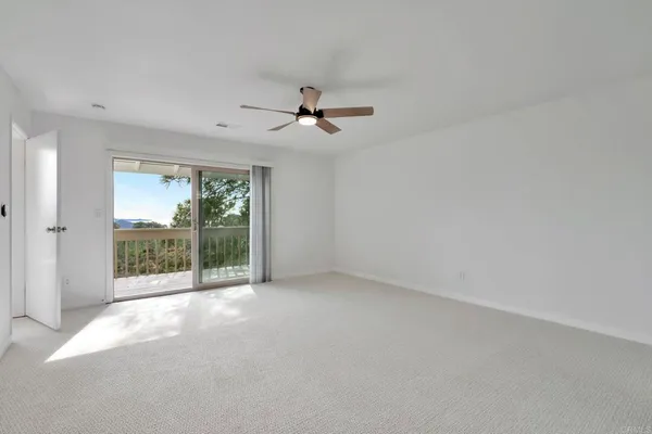 en empty room with windows and outdoor view