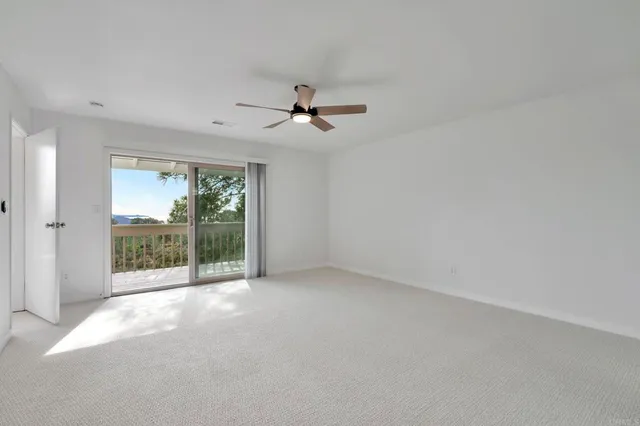 en empty room with windows and outdoor view