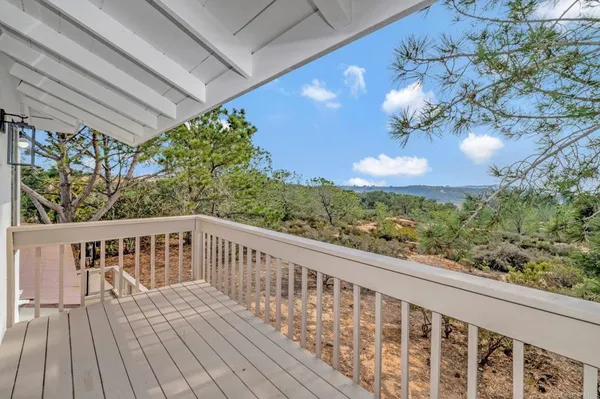 a view of a balcony with wooden floor