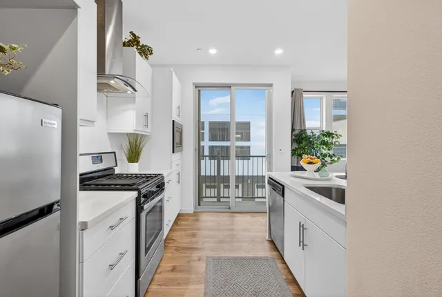 a kitchen with stainless steel appliances granite countertop a stove and a refrigerator