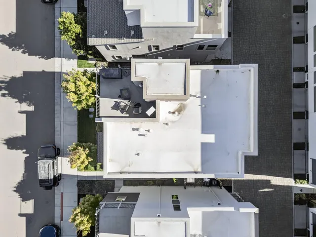 an aerial view of residential houses with outdoor space