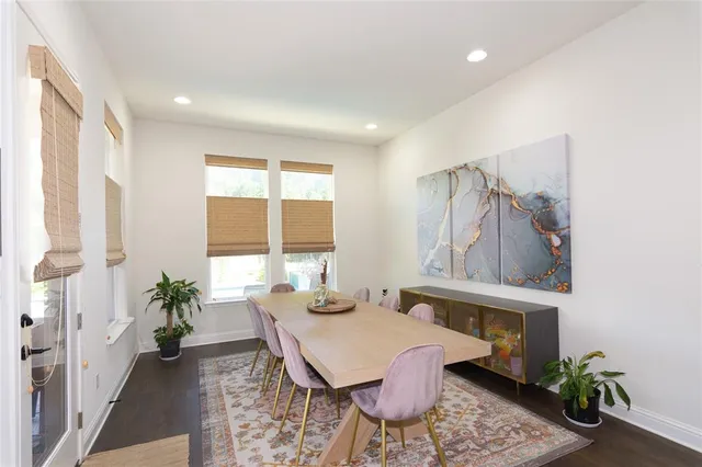 a living room with furniture and large windows