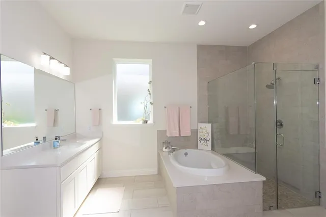 a bathroom with a double vanity sink mirror and