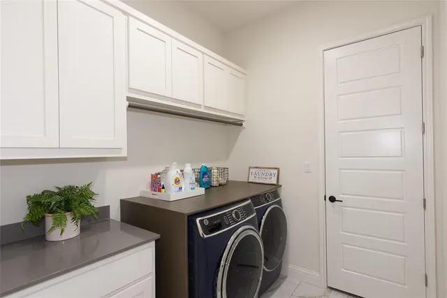 a utility room with sink dryer and washer