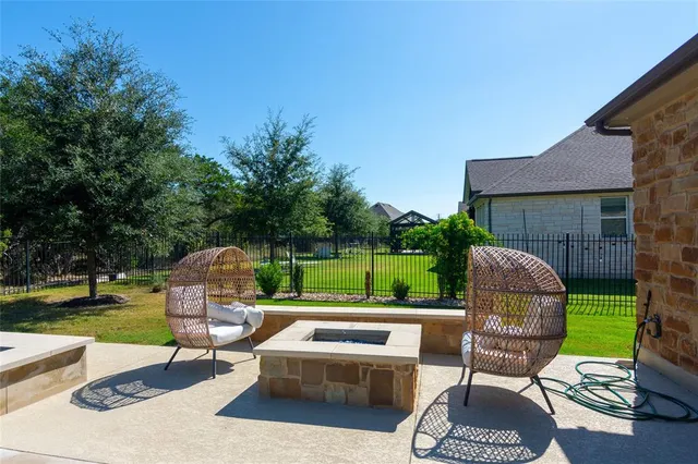 an outdoor sitting area with furniture and garden