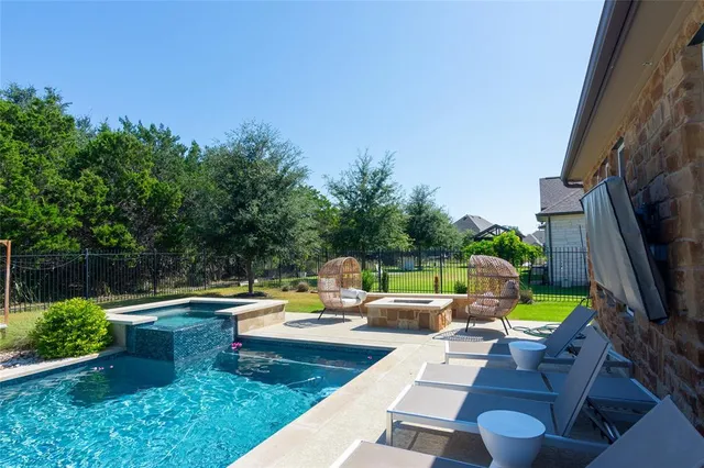 a view of a swimming pool with a patio