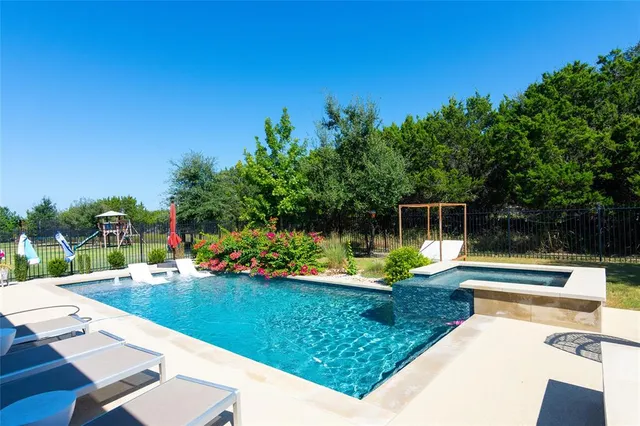 swimming pool view with a garden space