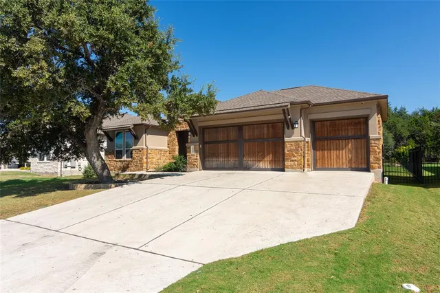 a view of a house with a yard and garage