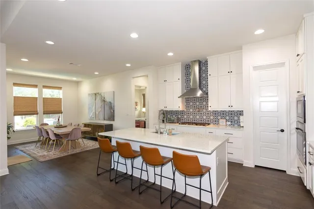 a large kitchen with a table and chairs