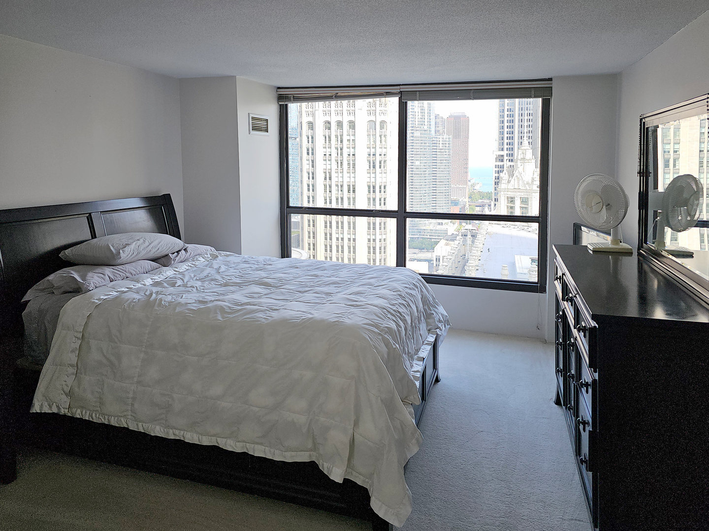 405 North Wabash Avenue, Unit 2613 Chicago, IL 60611 - Photo 12 of 24 a bed sitting in a bedroom next to a window