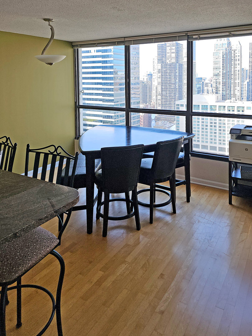 405 North Wabash Avenue, Unit 2613 Chicago, IL 60611 - Photo 5 of 24 a view of a dining room with furniture and window