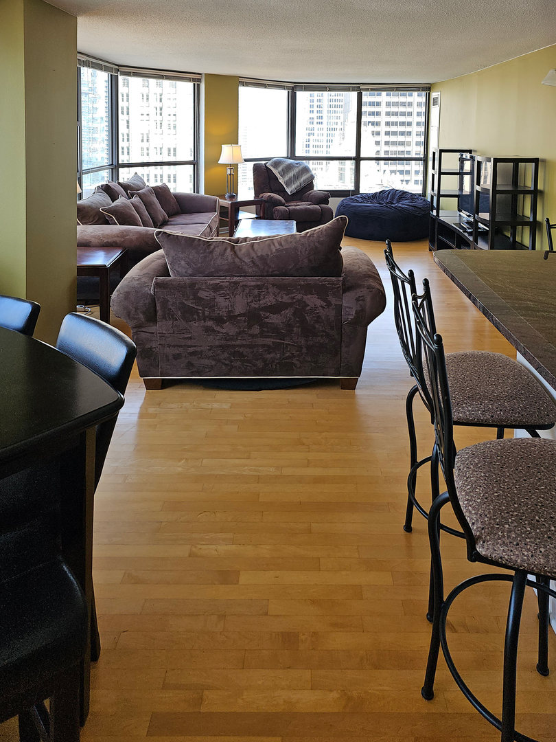 405 North Wabash Avenue, Unit 2613 Chicago, IL 60611 - Photo 7 of 24 a living room with fireplace furniture and a windows