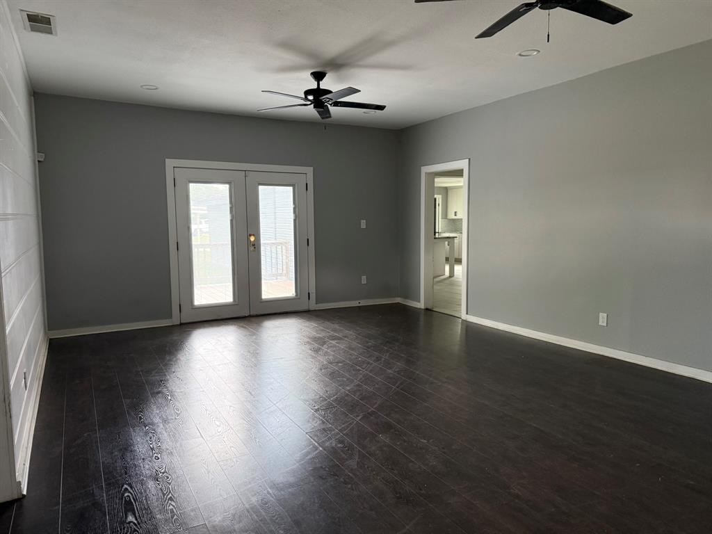 202 4th Street Joshua, TX 76058 - Photo 11 of 39 a view of an empty room with wooden floor and a window
