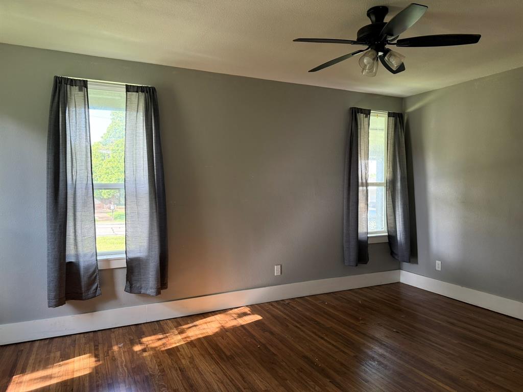 202 4th Street Joshua, TX 76058 - Photo 13 of 39 an empty room with wooden floor and windows