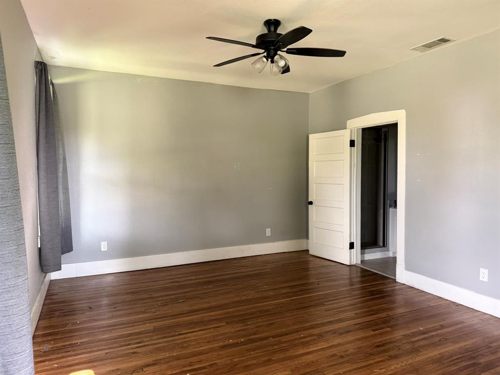 202 4th Street Joshua, TX 76058 - Photo 16 of 39 an empty room with wooden floor and windows