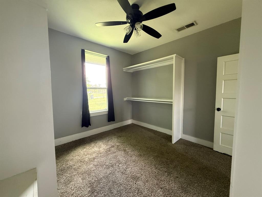 202 4th Street Joshua, TX 76058 - Photo 30 of 39 an empty room with windows and fan