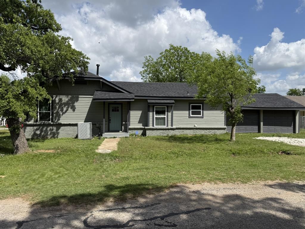 202 4th Street Joshua, TX 76058 - Photo 34 of 39 a front view of a house with a garden