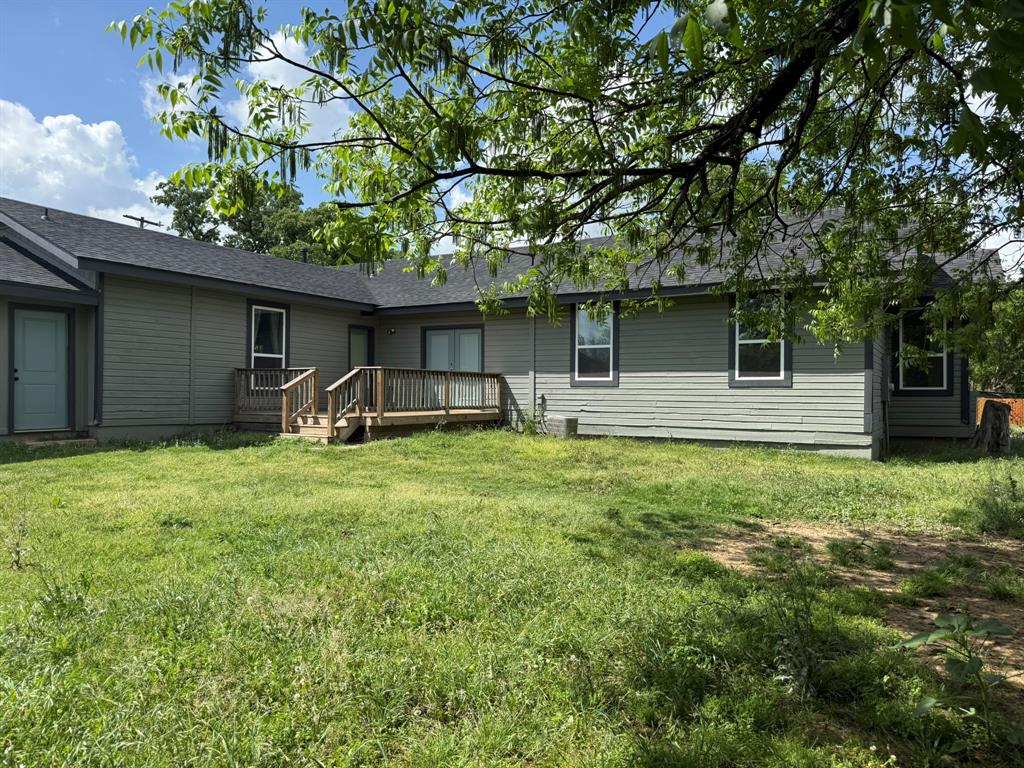 202 4th Street Joshua, TX 76058 - Photo 35 of 39 a front view of house with yard and outdoor seating