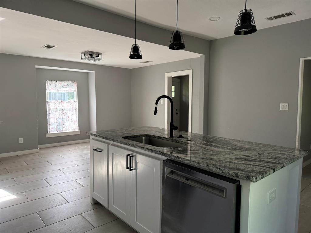 202 4th Street Joshua, TX 76058 - Photo 6 of 39 a kitchen with a stove and a sink