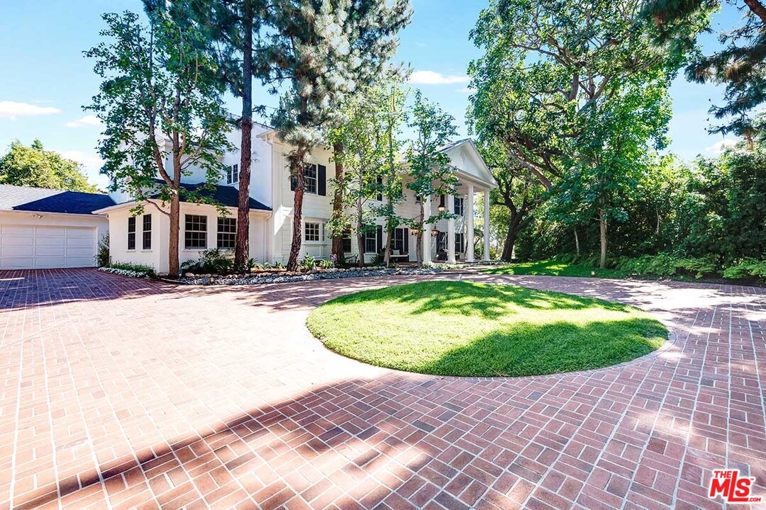 11610 Bellagio Road Los Angeles, CA 90049 - Photo 2 of 46 a swimming pool with outdoor seating and yard