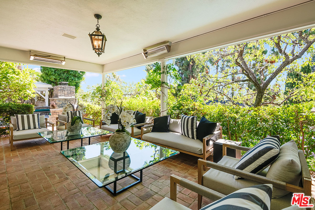 11610 Bellagio Road Los Angeles, CA 90049 - Photo 12 of 46 a outdoor living space with furniture and garden view