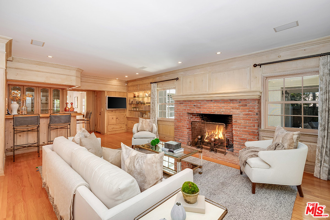 11610 Bellagio Road Los Angeles, CA 90049 - Photo 15 of 46 a living room with furniture and a fireplace