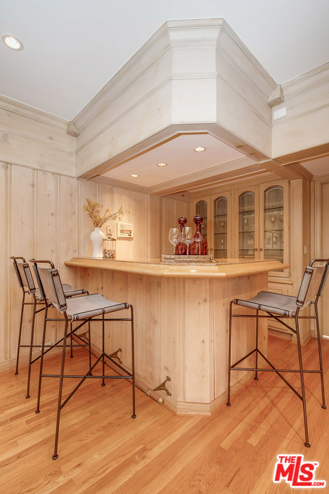 11610 Bellagio Road Los Angeles, CA 90049 - Photo 16 of 46 a living room with a table and chairs