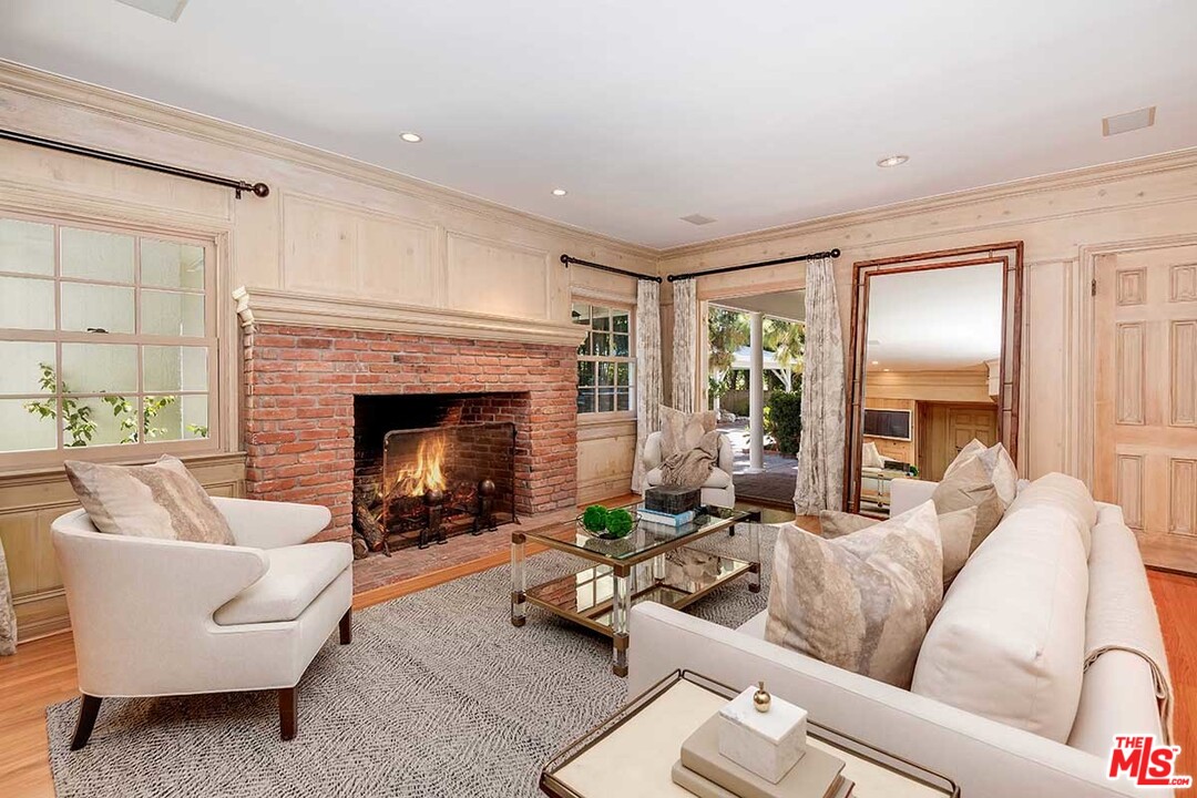 11610 Bellagio Road Los Angeles, CA 90049 - Photo 17 of 46 a living room with furniture and a fireplace