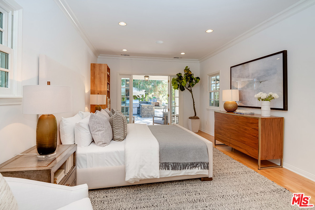 11610 Bellagio Road Los Angeles, CA 90049 - Photo 22 of 46 a bedroom with a bed and a dresser
