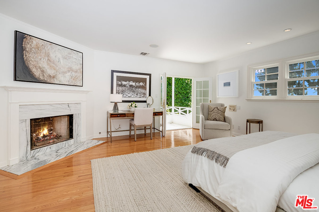 11610 Bellagio Road Los Angeles, CA 90049 - Photo 27 of 46 a living room with furniture large window and a fireplace