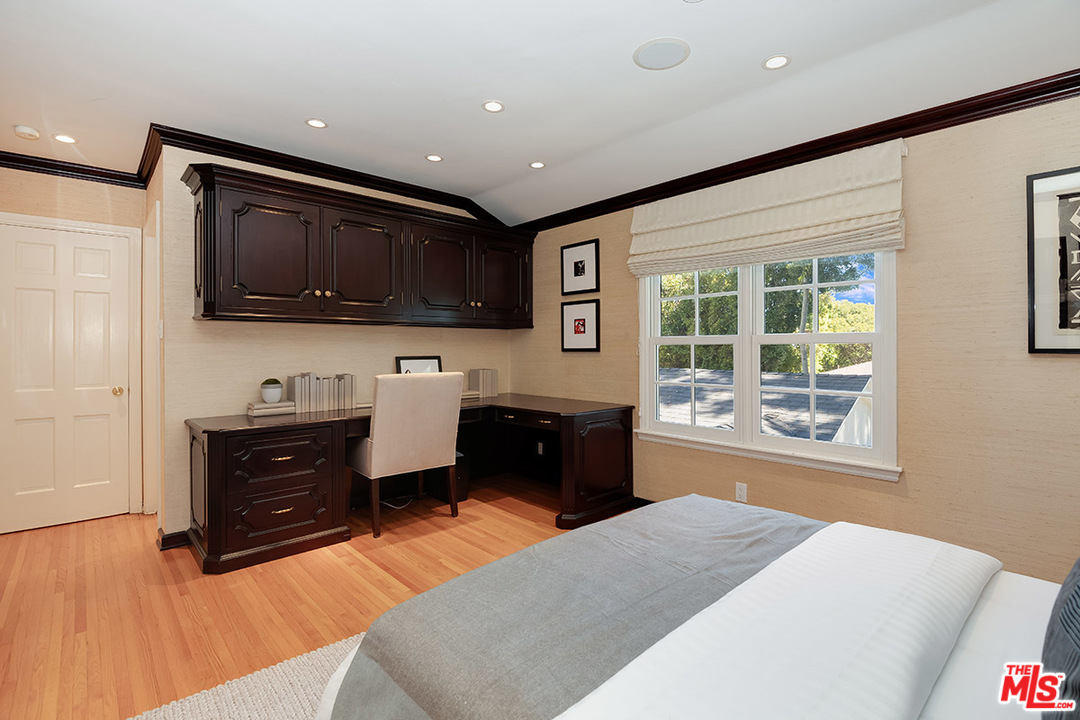 11610 Bellagio Road Los Angeles, CA 90049 - Photo 35 of 46 a living room with stainless steel appliances furniture a flat screen tv and a window