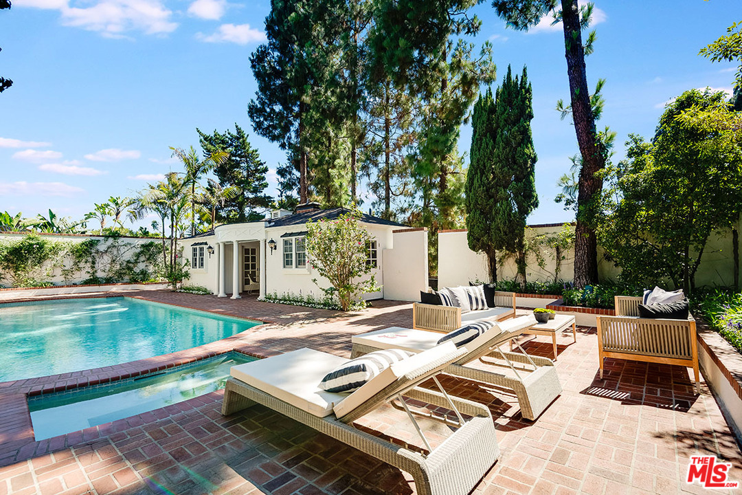 11610 Bellagio Road Los Angeles, CA 90049 - Photo 39 of 46 a view of backyard with swimming pool and seating space