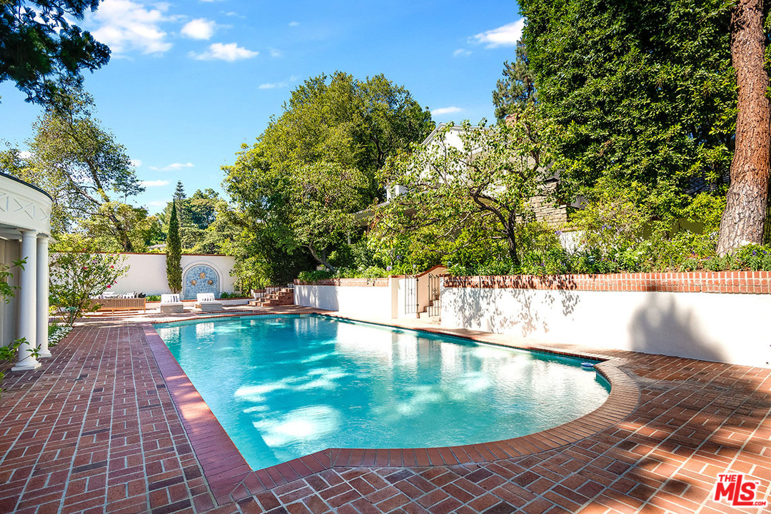 11610 Bellagio Road Los Angeles, CA 90049 - Photo 40 of 46 a view of a swimming pool with an outdoor space