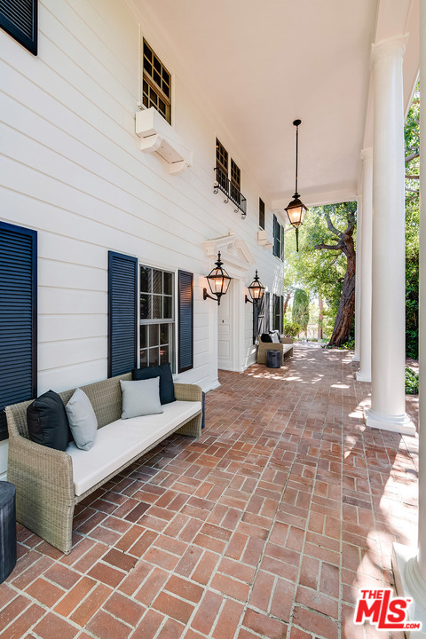 11610 Bellagio Road Los Angeles, CA 90049 - Photo 5 of 46 a view of living room filled with furniture and floor to ceiling window
