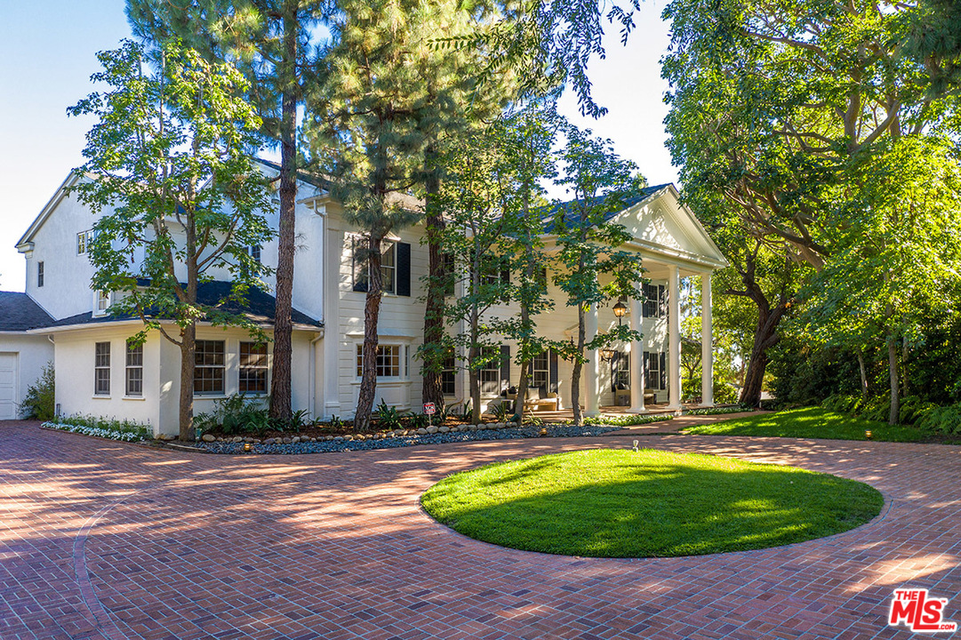 11610 Bellagio Road Los Angeles, CA 90049 - Photo 44 of 46 a front view of a house with a yard