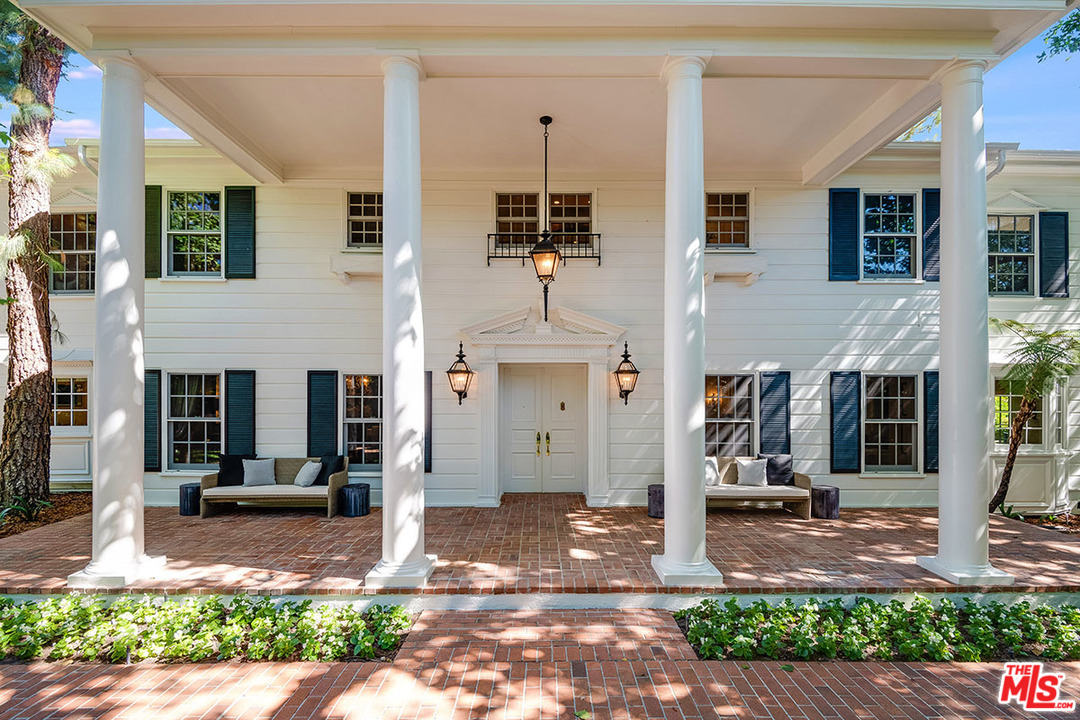 11610 Bellagio Road Los Angeles, CA 90049 - Photo 6 of 46 a front view of a house with a yard