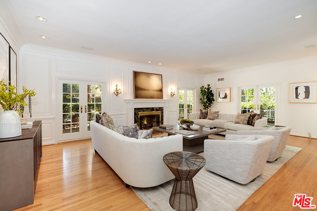 11610 Bellagio Road Los Angeles, CA 90049 - Photo 8 of 46 a living room with fireplace furniture and a wooden floor