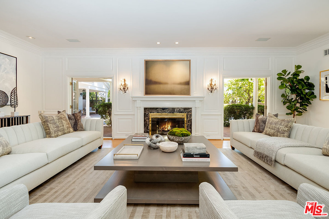 11610 Bellagio Road Los Angeles, CA 90049 - Photo 10 of 46 a living room with furniture and a fireplace