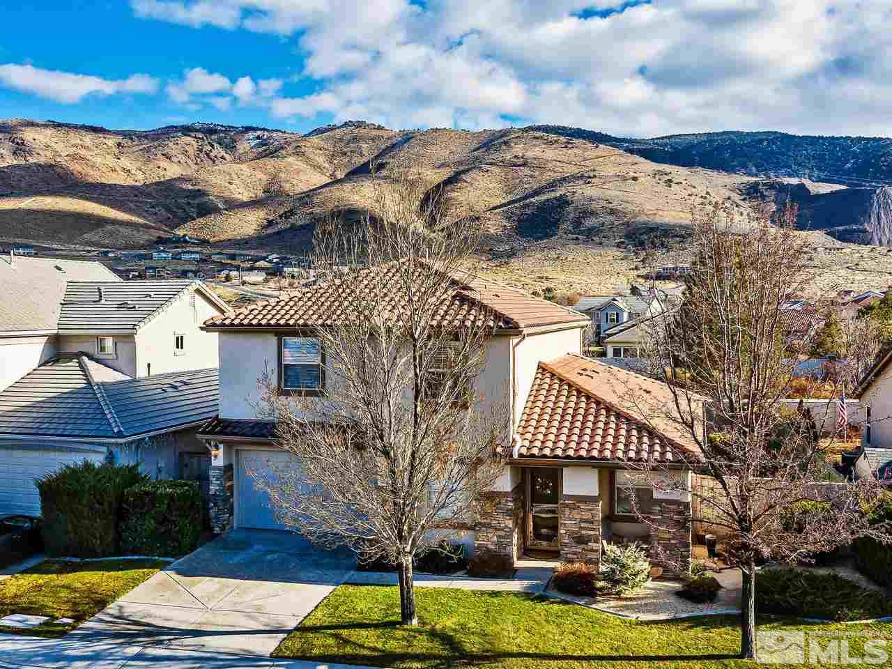 10588 Fort Morgan Way Reno, NV 89521 - Photo 1 of 24 a front view of a house with garden