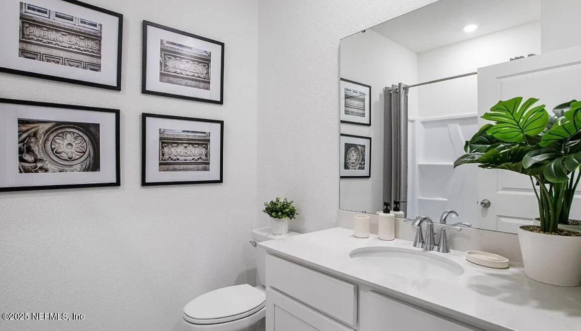 73 Whitmore Drive St. Augustine, FL 32092 - Photo 21 of 30 a white toilet sitting next to a bathroom sink