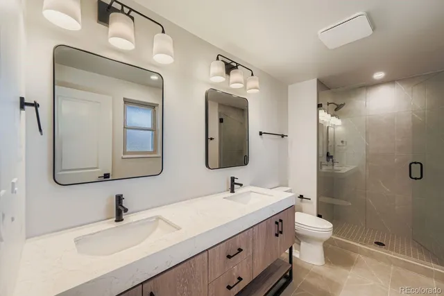 a spacious bathroom with a double vanity sink and mirror