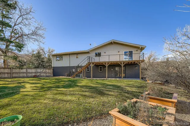 a view of a house with pool and chairs