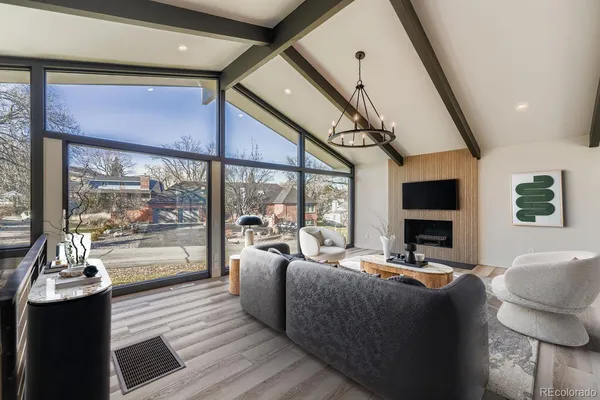 a living room with furniture fireplace and flat screen tv