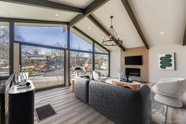 a living room with furniture fireplace and flat screen tv