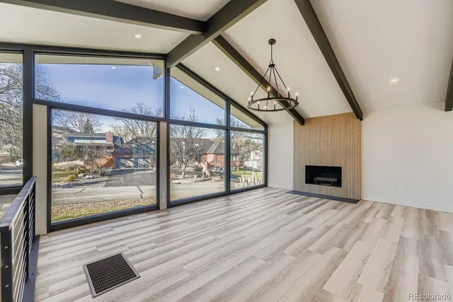 a view of empty room with wooden floor and fireplace