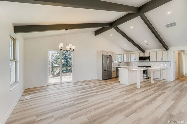 a view of a kitchen with a sink and cabinets