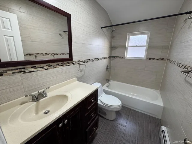 a bathroom with a sink mirror toilet and bathtub
