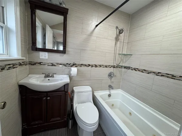 a bathroom with a toilet sink and mirror