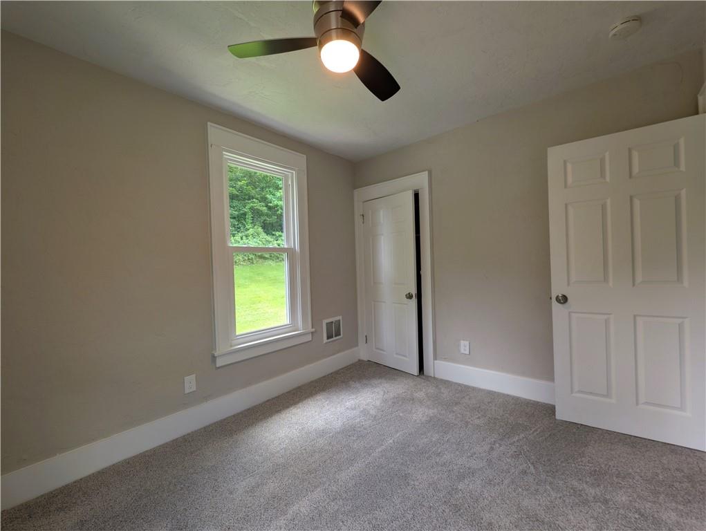 555 Steel Hill Road Mount Morris, PA 15349 - Photo 12 of 19 a view of empty room with windows and chandelier fan
