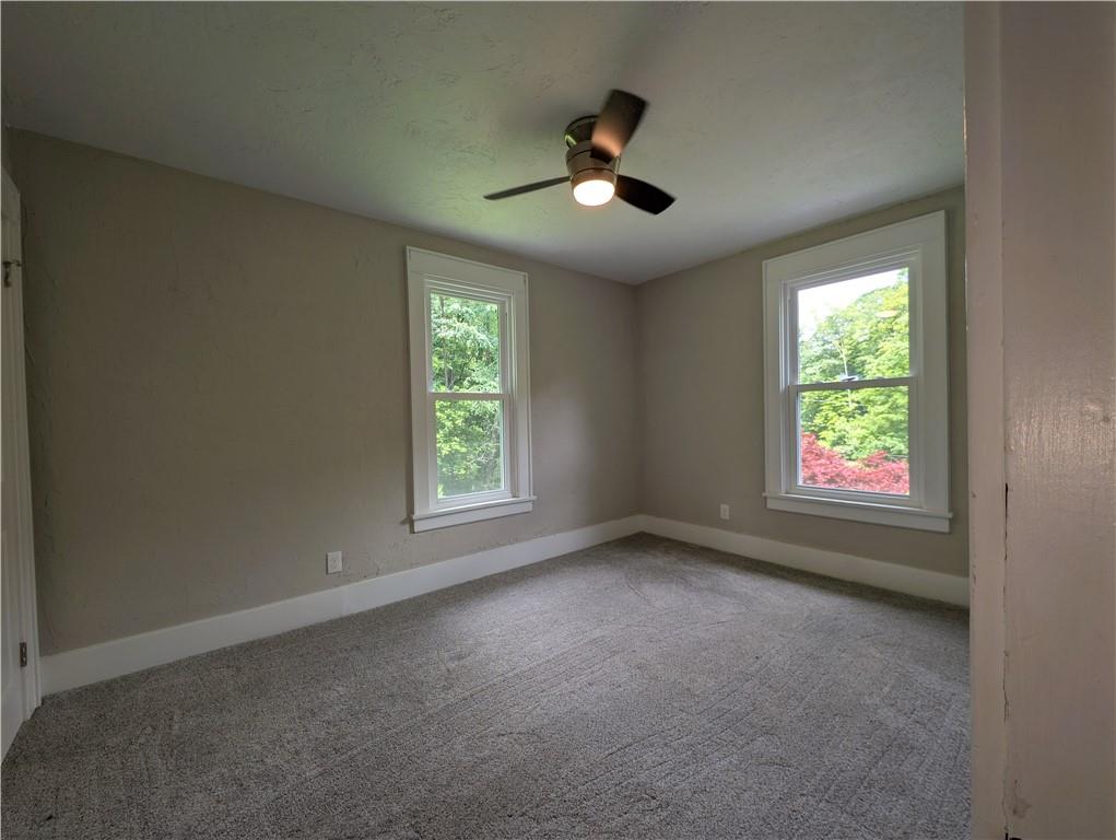 555 Steel Hill Road Mount Morris, PA 15349 - Photo 14 of 19 an empty room with windows and chandelier fan